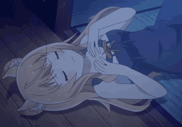 a girl with a cat ear is laying down with her eyes closed
