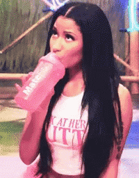 a woman is drinking from a pink bottle and wearing a shirt that says " i 'm at her butt "
