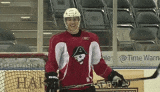 a hockey player in a red jersey with a skull on it