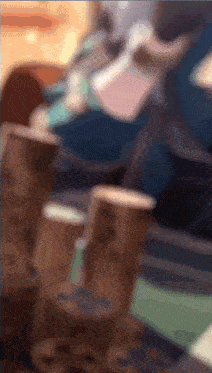 a blurry picture of a person sitting at a table with a stack of mcdonald 's cups on it