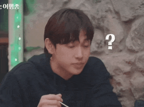 a man with a question mark on his face is eating something