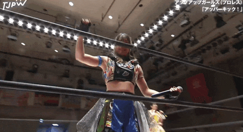 a woman in a wrestling ring with the letters tjpw on the top