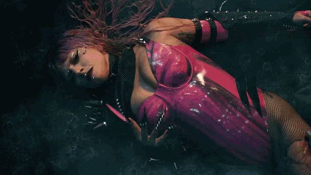 a woman in a pink and black outfit is laying on the ground