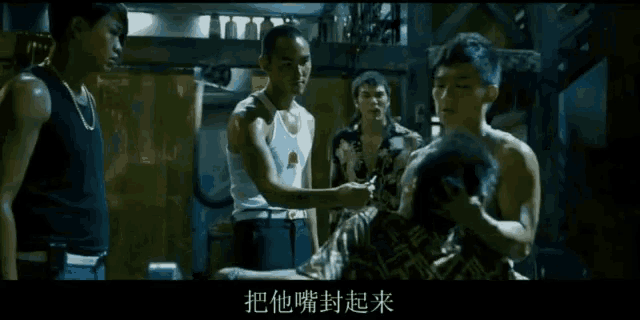 a man is being choked by another man with chinese writing on the screen