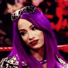 a woman with purple hair is wearing sunglasses and a crown on her head .