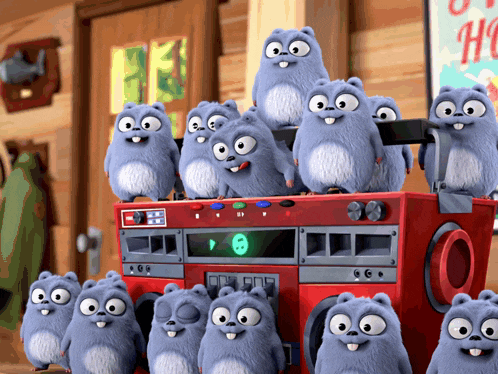 a bunch of stuffed animals are sitting on top of a red boombox