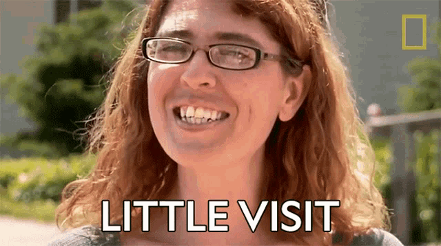 a woman wearing glasses is smiling with the words little visit behind her