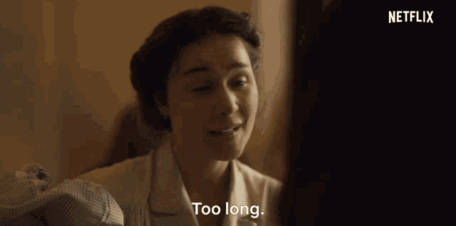 a woman in a white shirt is talking to another woman and says too long