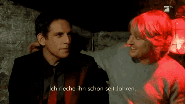 two men are standing next to each other and one of them says ich rieche ihn schon seit jahren