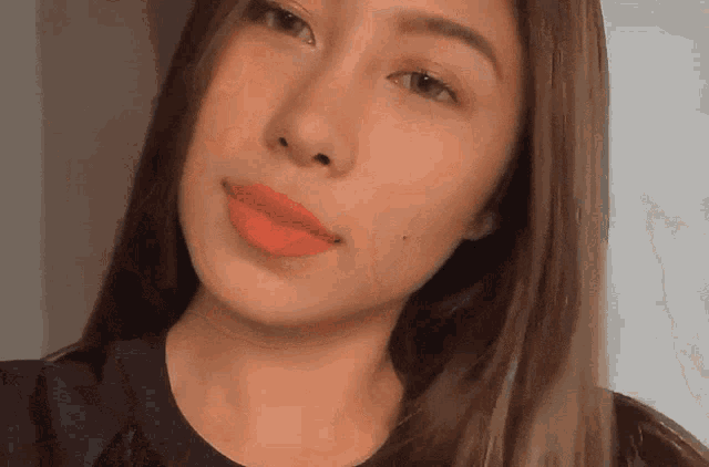 a close up of a woman 's face with red lipstick on