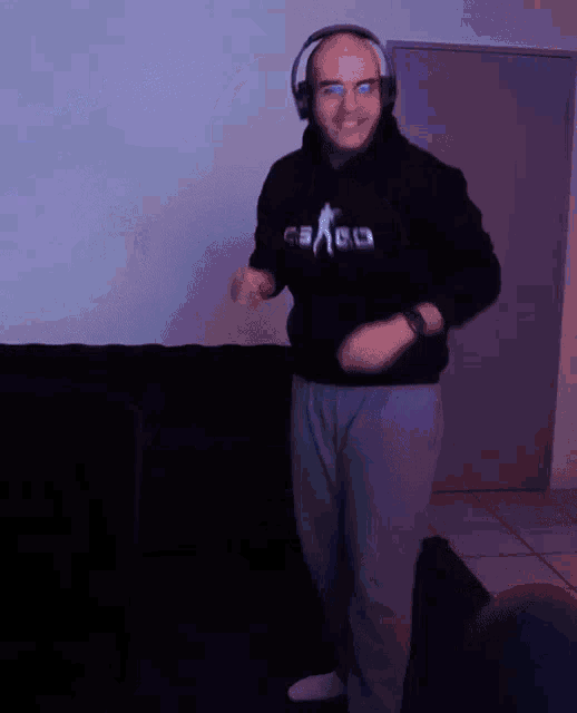a man wearing headphones and a cs go hoodie