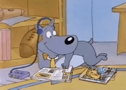 a dog wearing headphones is reading a magazine