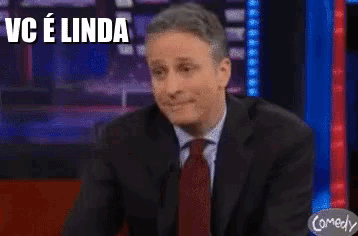 a man in a suit with hearts in his eyes and the words vc e linda above him