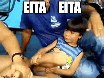 a man is holding a little boy in his arms with the words eita eita written on the bottom .
