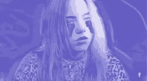 billie eilish is wearing a leopard print shirt and has tears on her face .