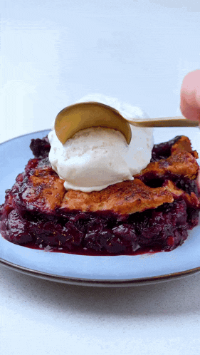 a person is scooping ice cream on top of a pie on a plate