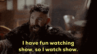 a man with a beard is talking about watching a show