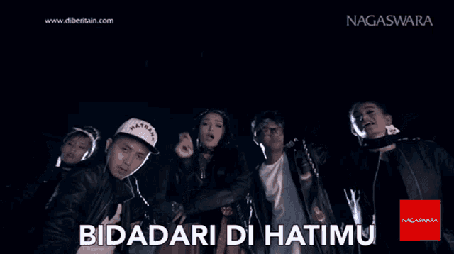 a group of people standing next to each other with the words bidadari di hatimu on the bottom right