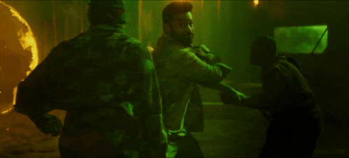 a man in a green shirt with the number 19 on it fighting another man