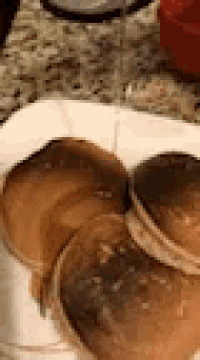 three pancakes are stacked on top of each other on a plate .