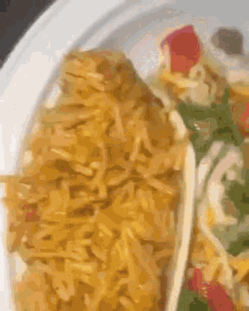 a close up of a plate of food with rice and a taco on it .