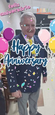 a man in a suit and tie is surrounded by balloons and confetti and the words happy anniversary