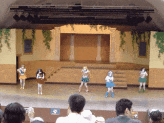 a group of women are dancing on a stage with a sign that says " vip "