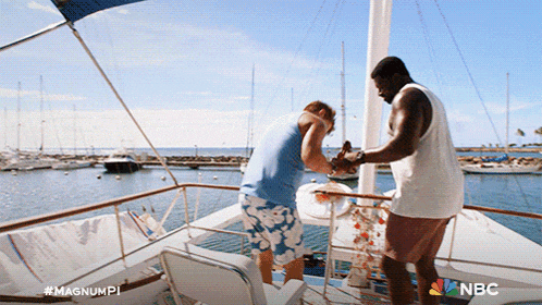 two men on a boat with the nbc logo on the bottom