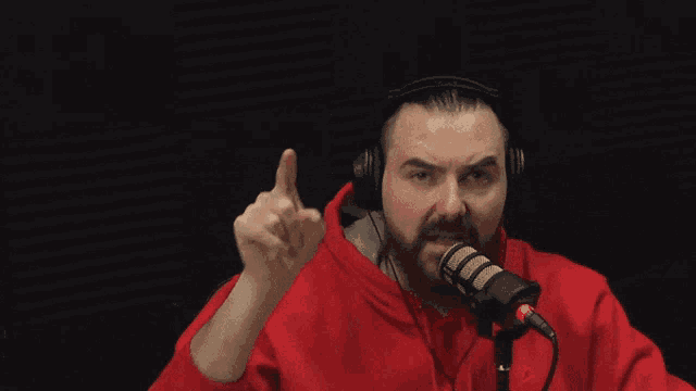 a man wearing headphones holds a microphone and says i demand justice