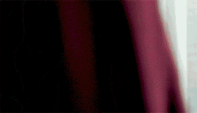 a close up of a red curtain with a white background .