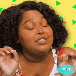 a woman with curly hair is making a face with her eyes closed