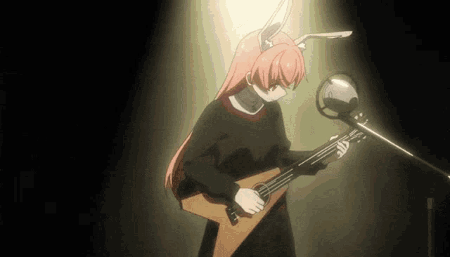 a girl with pink hair and bunny ears is playing a guitar in front of a microphone