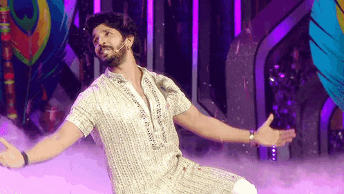 a man with his arms outstretched on a stage
