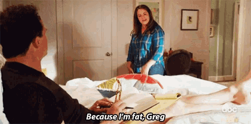 a man sits on a bed talking to a woman who says because i 'm fat