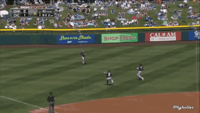 a baseball game is being played in a stadium with advertisements for shop mesa and cal am