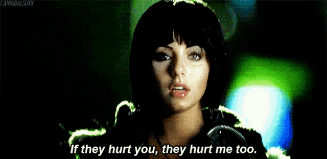 a woman in a green jacket says " if they hurt you they hurt me too "
