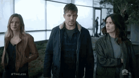 a group of people standing next to each other with the hashtag #timeless