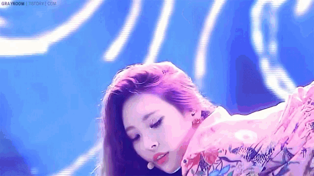 a close up of a woman 's face with a purple background .
