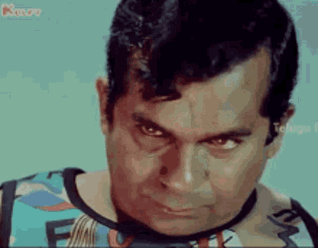 a close up of a man 's face with a very angry look on his face .