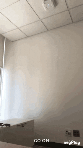 a room with a white wall and a ceiling that says ' go on ' on it