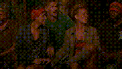 a group of people are sitting next to each other in a forest .