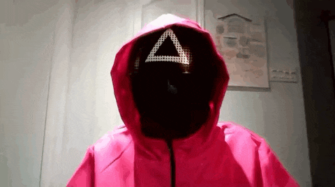 a person wearing a pink jacket with a triangle on their face .