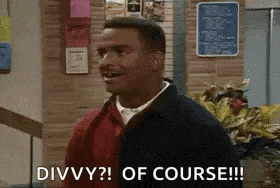 a man is standing in front of a wall and saying divvy ? of course !