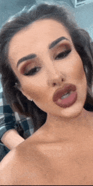 a close up of a woman 's face with big lips