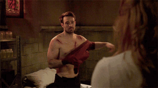 a shirtless man is standing next to a woman
