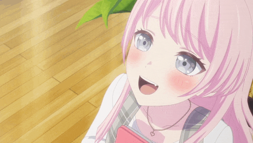 a girl with pink hair is smiling while taking a selfie