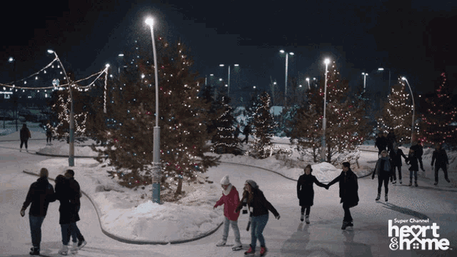 a group of people are ice skating in a park sponsored by super channel heart & home