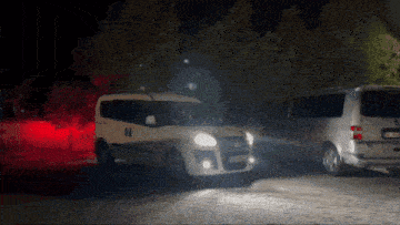 a white van with a license plate that starts with the letter k