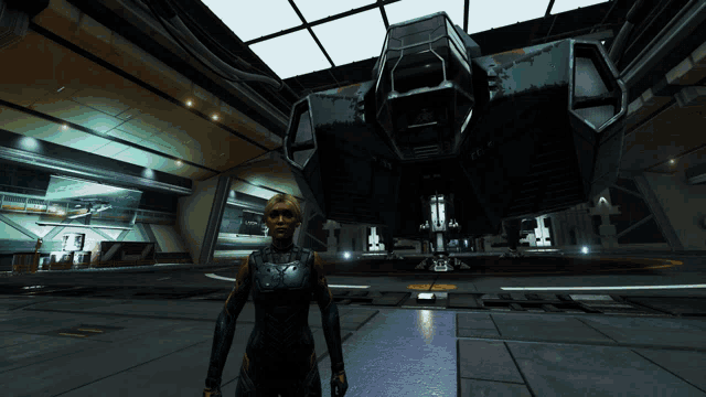 a woman stands in front of a large space ship in a hanger