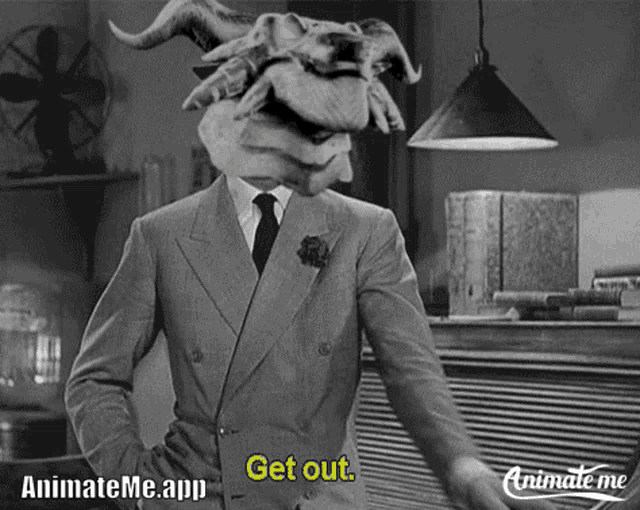a black and white photo of a man in a suit and tie with a monster head saying " get out "